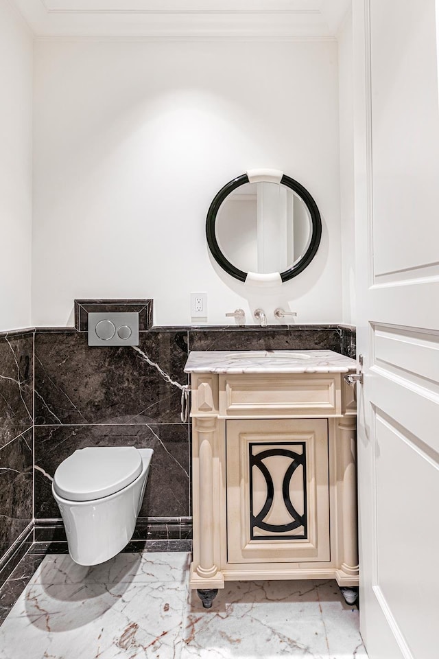 27 E 79th St Unit Duplex7/8, New York City, NY 10075 - half bathroom with marble tiled flooring, vanity, tile walls, wainscoting, and toilet