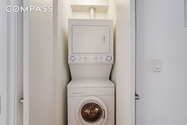 laundry area with stacked washing maching and dryer and laundry area