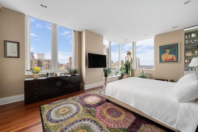 300 E 77th St Unit 30B, New York City, NY 10075 - bedroom with wood finished floors, multiple windows, and baseboards