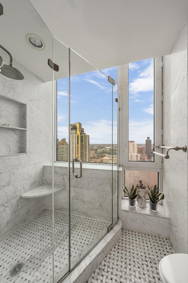 300 E 77th St Unit 30B, New York City, NY 10075 - bathroom with a marble finish shower, a city view, and toilet