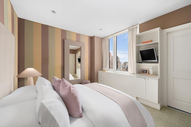 300 E 77th St Unit 30B, New York City, NY 10075 - bedroom with light carpet and wallpapered walls
