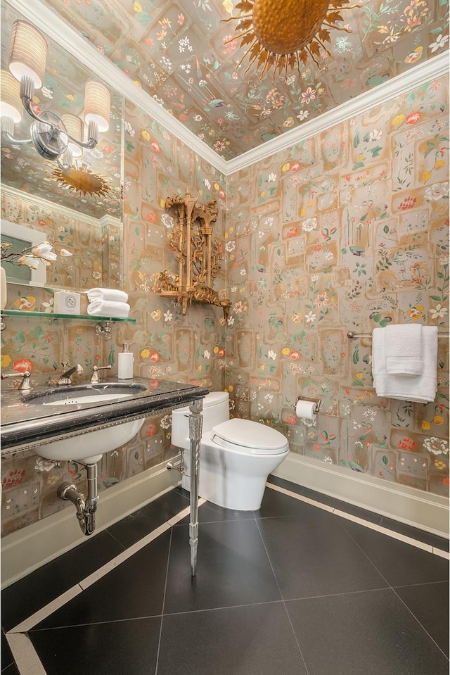 300 E 77th St Unit 30B, New York City, NY 10075 - bathroom featuring crown molding, toilet, wallpapered walls, a sink, and tile patterned flooring