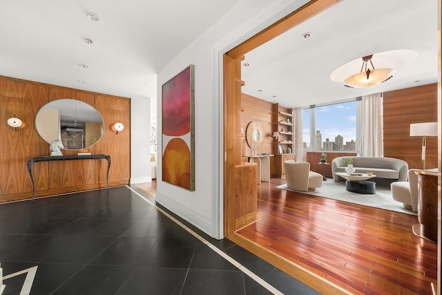 300 E 77th St Unit 30B, New York City, NY 10075 - corridor with wood walls, built in shelves, baseboards, and a view of skyline
