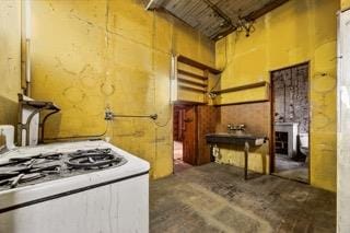 465 W Broadway Unit 3-S, New York City, NY 10012 - kitchen with unfinished concrete floors and white range with gas cooktop