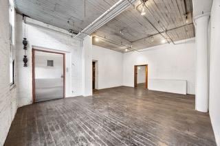 empty room with brick patterned flooring