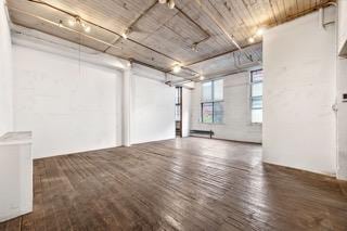 unfurnished living room with wood-type flooring