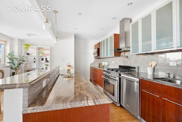 301 W 115th St Unit Ph4C, New York City, NY 10026 - kitchen with wall chimney exhaust hood, stainless steel appliances, and modern cabinets
