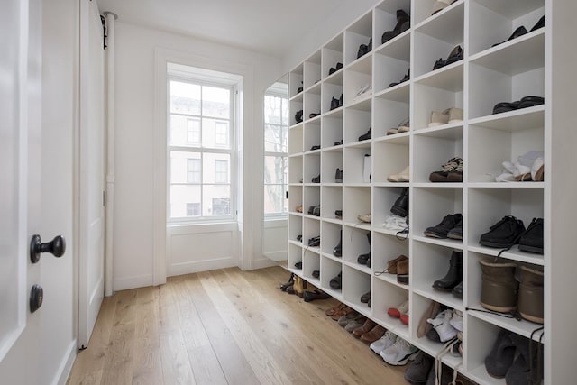 mudroom featuring baseboards and light wood-type flooring