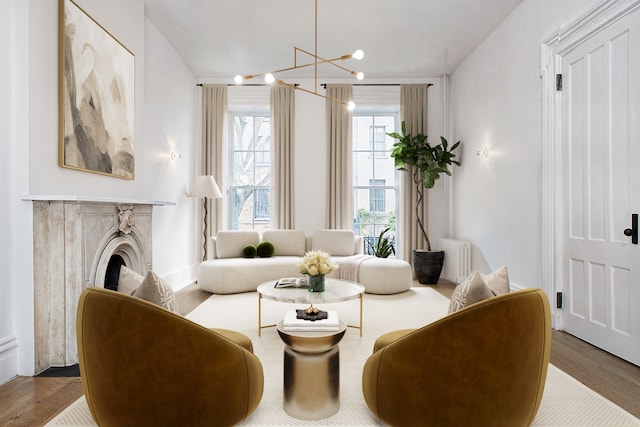 sitting room featuring radiator, a fireplace, and wood finished floors