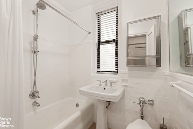 bathroom with shower / bathtub combination with curtain and tile walls