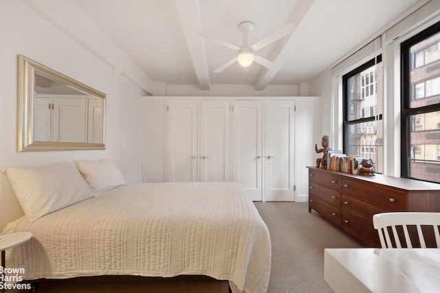 bedroom featuring beamed ceiling, carpet flooring, and ceiling fan