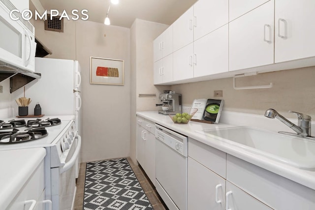166 E 61st St Unit 7E, New York City, NY 10065 - kitchen featuring white appliances, a sink, white cabinets, light countertops, and dark tile patterned floors