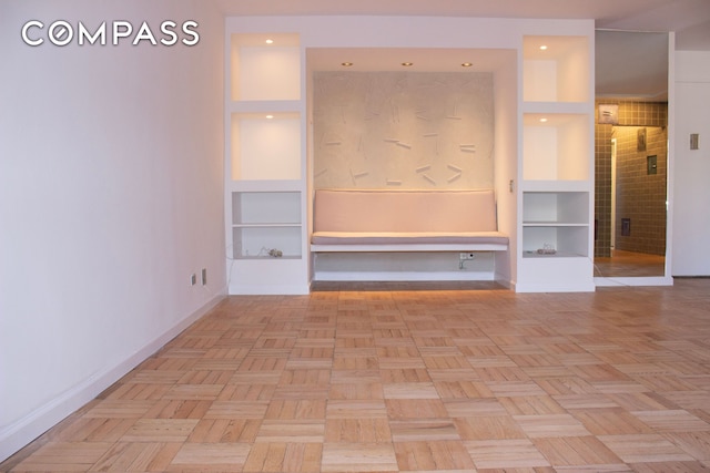 166 E 61st St Unit 7E, New York City, NY 10065 - unfurnished living room with baseboards
