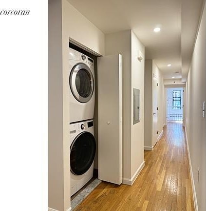 420 Classon Ave Unit C, New York City, NY 11238 - laundry room with laundry area, visible vents, baseboards, stacked washer and clothes dryer, and light wood-style flooring