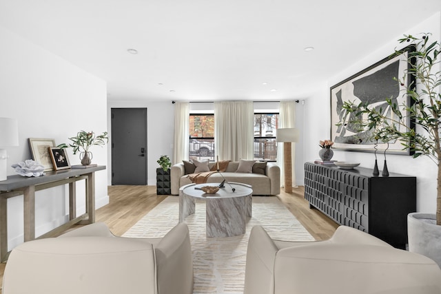 living area with light wood-style floors and recessed lighting
