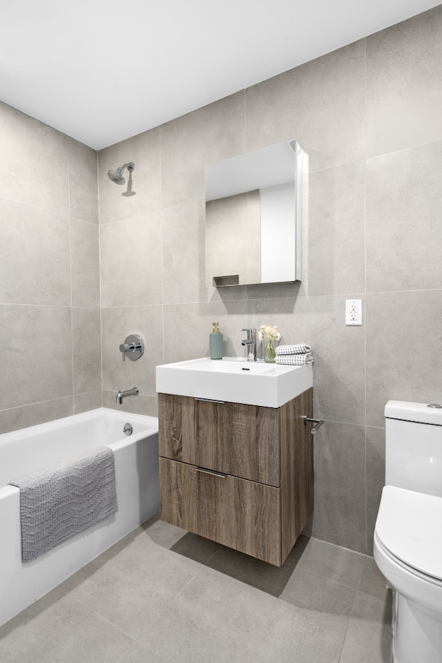 256 Putnam Ave Unit 1, New York City, NY 11216 - bathroom featuring tile walls, vanity, tile patterned flooring, and washtub / shower combination