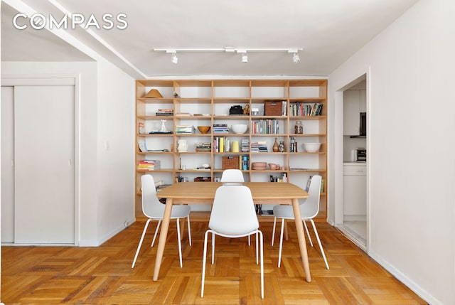 dining room featuring track lighting
