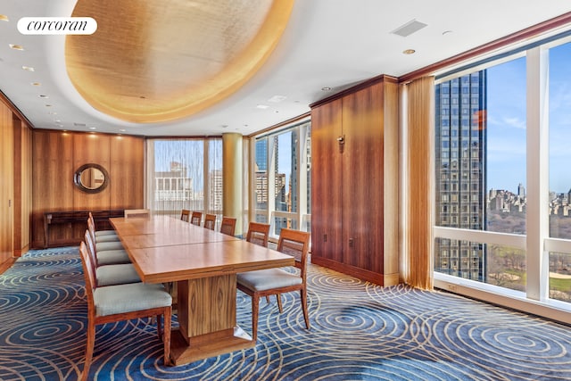 25 Columbus Cir Unit 56F, New York City, NY 10019 - dining area featuring wooden walls, plenty of natural light, a view of city, a tray ceiling, and recessed lighting