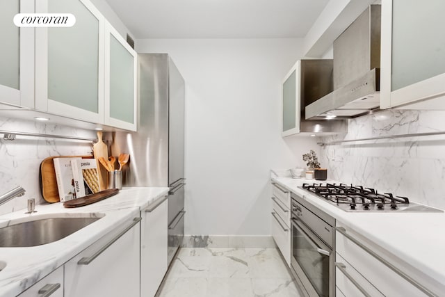25 Columbus Cir Unit 56F, New York City, NY 10019 - kitchen with appliances with stainless steel finishes, light marble finish floors, tasteful backsplash, wall chimney exhaust hood, and white cabinetry