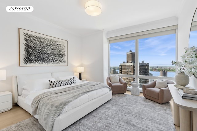 25 Columbus Cir Unit 56F, New York City, NY 10019 - bedroom featuring crown molding, wood finished floors, a water view, and a view of city