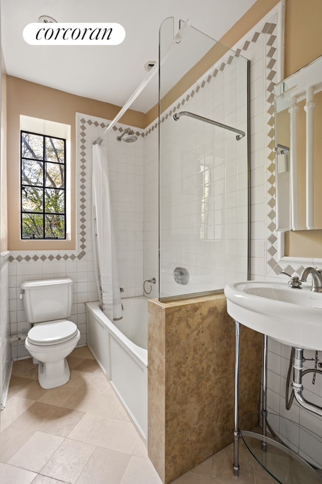 116 Pinehurst Ave Unit C15, New York City, NY 10033 - full bathroom with tile walls, tiled shower / bath combo, and tile patterned flooring