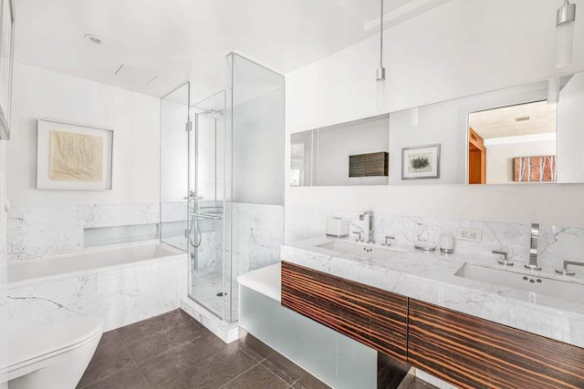 bathroom featuring tile patterned floors, a shower stall, toilet, a bath, and a sink