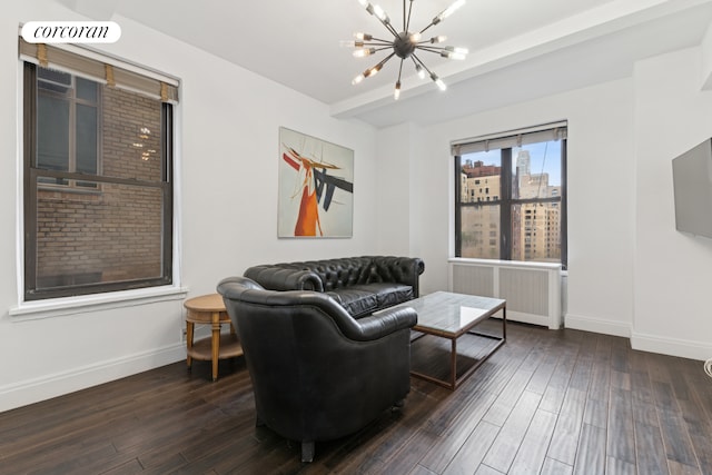 12 W 72nd St Unit 12D, New York City, NY 10023 - living room with radiator, a chandelier, baseboards, and hardwood / wood-style floors