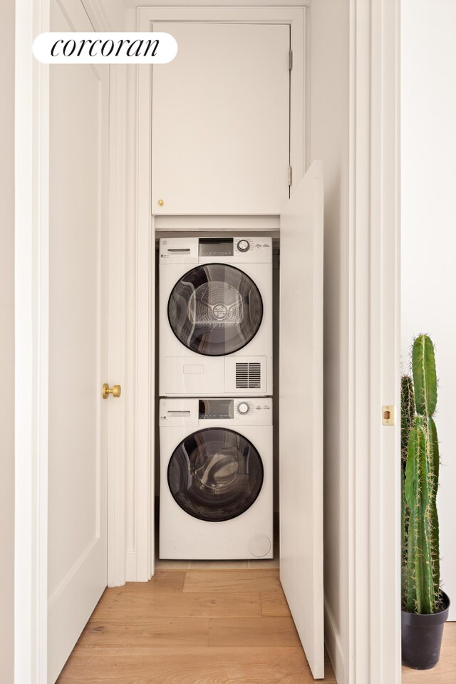 259 Rutland Rd Unit 2A, New York City, NY 11225 - laundry area featuring stacked washing machine and dryer and light wood-style floors
