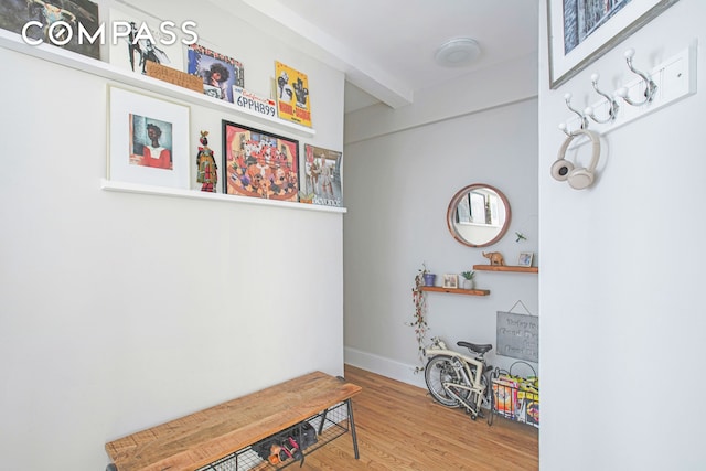 mudroom with wood finished floors, beam ceiling, and baseboards