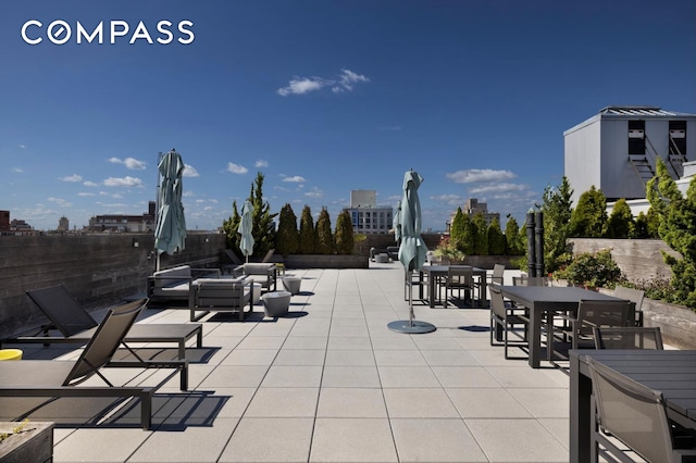 view of patio featuring outdoor dining space, fence, and outdoor lounge area