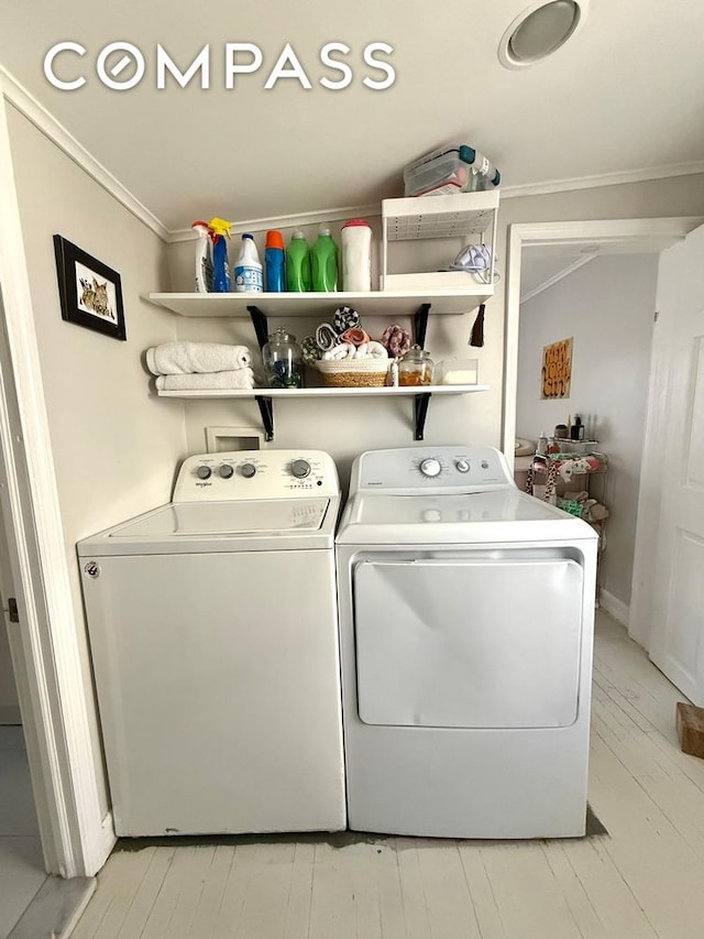 269 Ainslie St, New York City, NY 11211 - clothes washing area with crown molding, separate washer and dryer, light wood-style floors, and laundry area