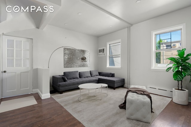 living room with baseboard heating, a wall mounted air conditioner, wood finished floors, and baseboards