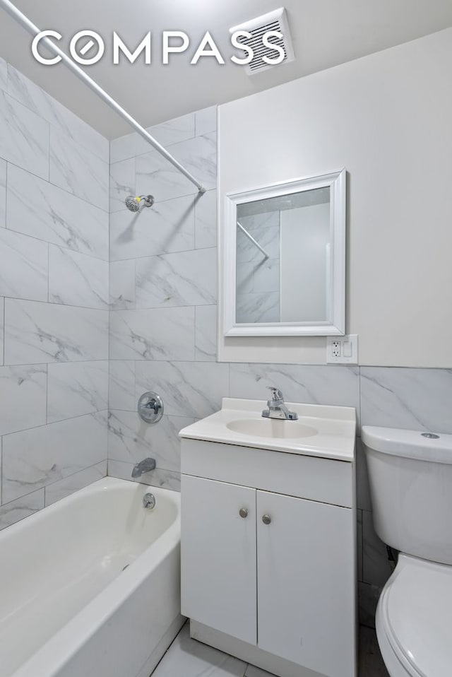 269 Ainslie St, New York City, NY 11211 - bathroom featuring toilet, shower / bath combination, tile walls, and visible vents