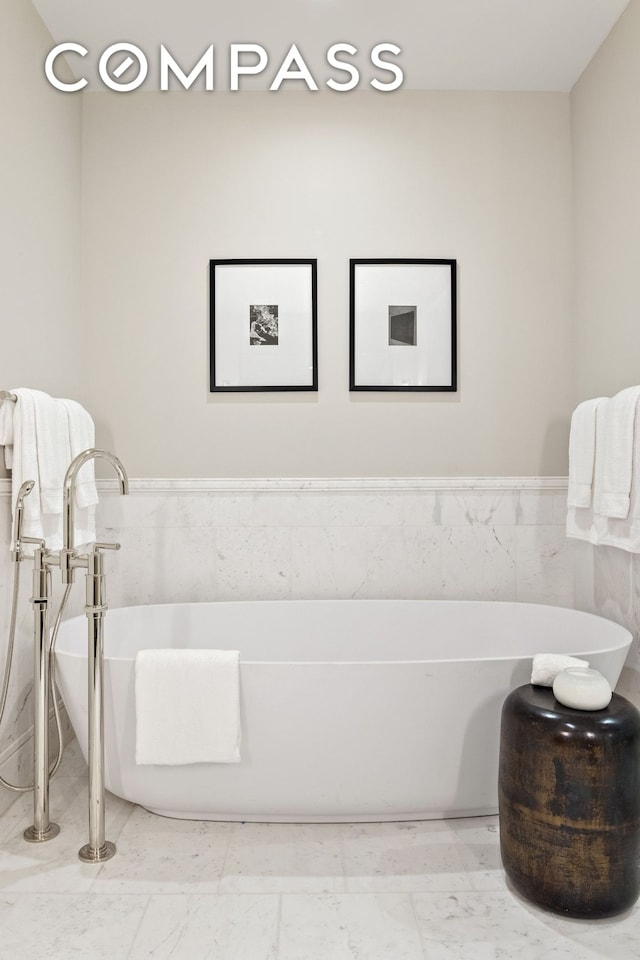 378 W End Ave Unit 11B, New York City, NY 10024 - bathroom with tile walls and a soaking tub