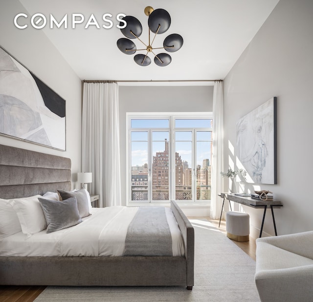 378 W End Ave Unit 11B, New York City, NY 10024 - bedroom featuring an inviting chandelier, a view of city, and wood finished floors