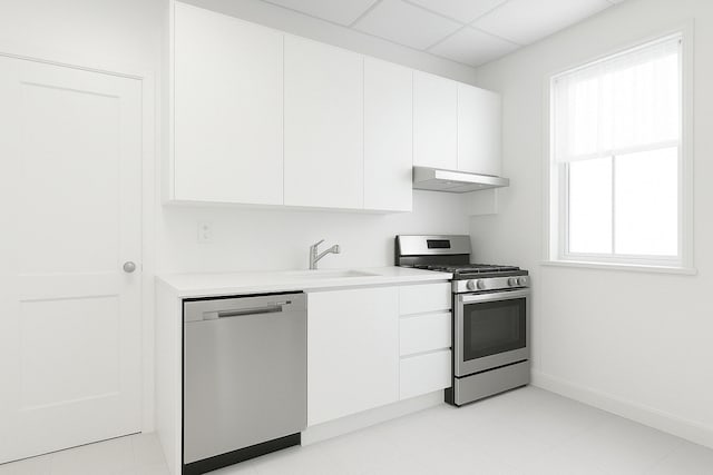 kitchen featuring stainless steel appliances, under cabinet range hood, light countertops, white cabinets, and a sink