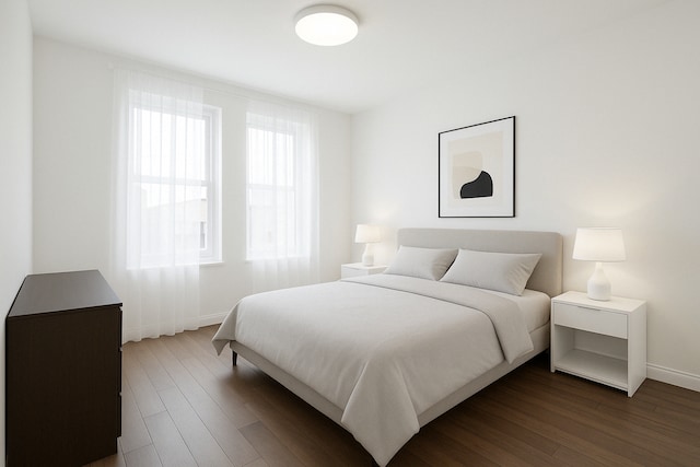 bedroom featuring dark wood-style floors and baseboards