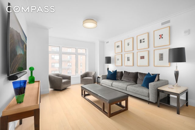 200 E 83rd St Unit 5D, New York City, NY 10028 - living area featuring light wood-style floors, ornamental molding, and baseboards