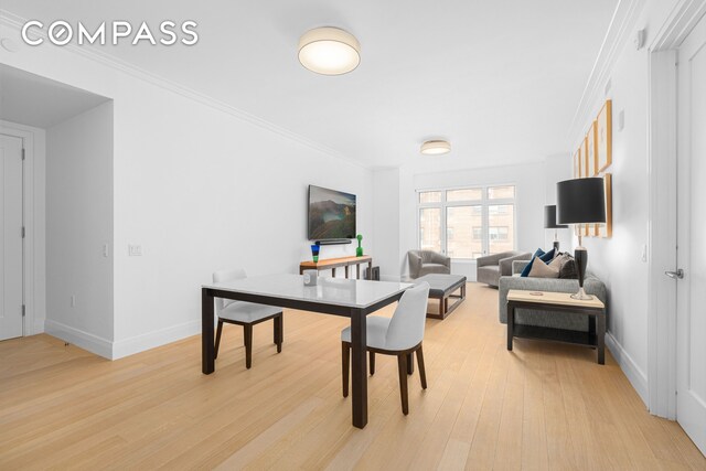 200 E 83rd St Unit 5D, New York City, NY 10028 - dining space featuring light wood finished floors, baseboards, and ornamental molding