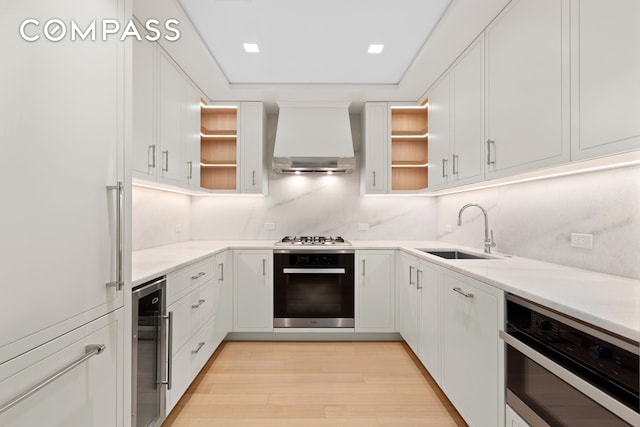 200 E 83rd St Unit 5D, New York City, NY 10028 - kitchen with stainless steel appliances, open shelves, custom exhaust hood, and wine cooler