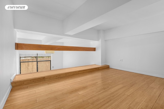 empty room with wood finished floors and baseboards