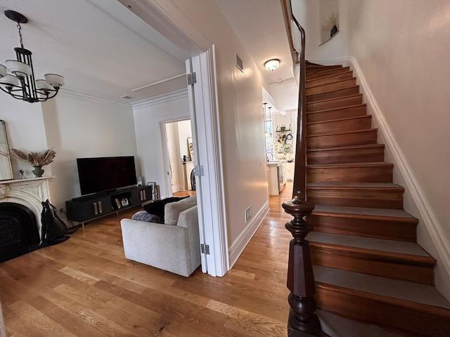 6 3rd St, New York City, NY 11231 - stairway with visible vents, wood finished floors, baseboards, a chandelier, and ornamental molding