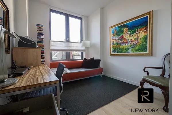 living area featuring baseboards and wood finished floors