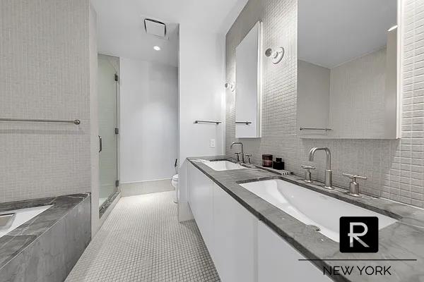 full bath featuring toilet, a shower stall, a bath, tile patterned flooring, and double vanity