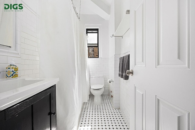 760 W End Ave Unit 1A, New York City, NY 10025 - bathroom with tile walls, vanity, and toilet