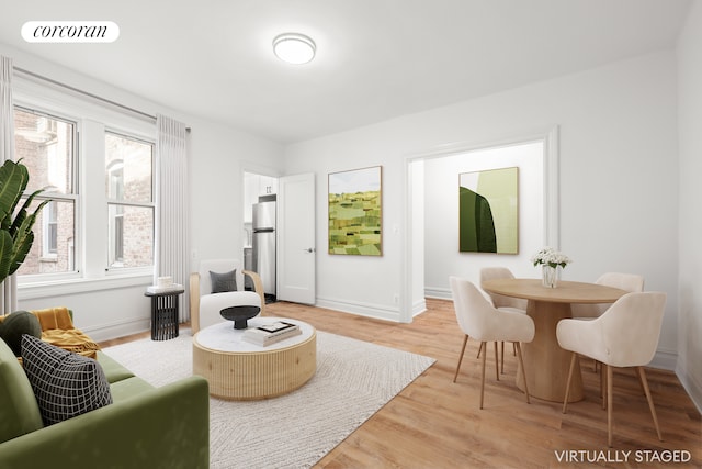 living room with light wood-type flooring and baseboards