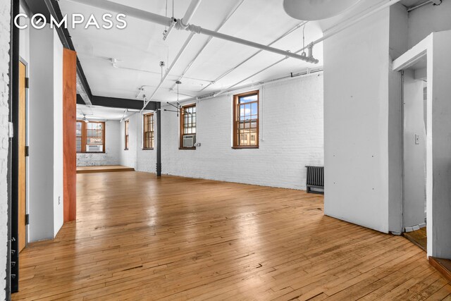 210 Spring St Unit 5, New York City, NY 10012 - interior space featuring light wood-type flooring and brick wall