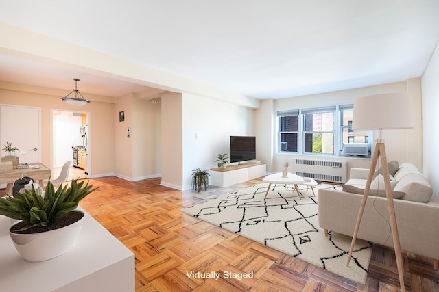 living area with radiator and baseboards