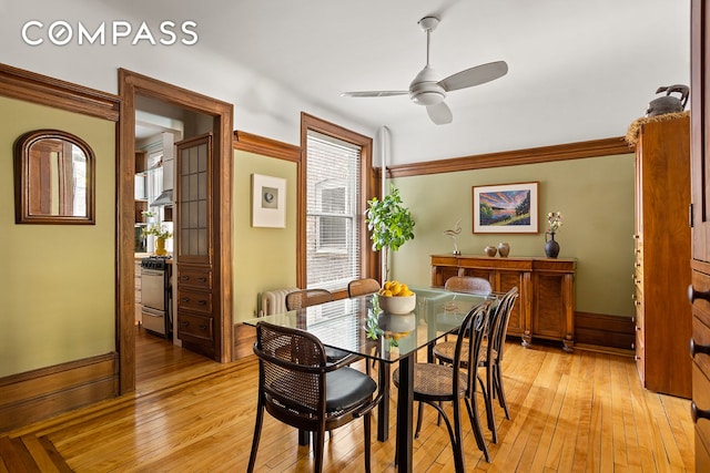 dining space featuring a healthy amount of sunlight, a ceiling fan, and light wood finished floors