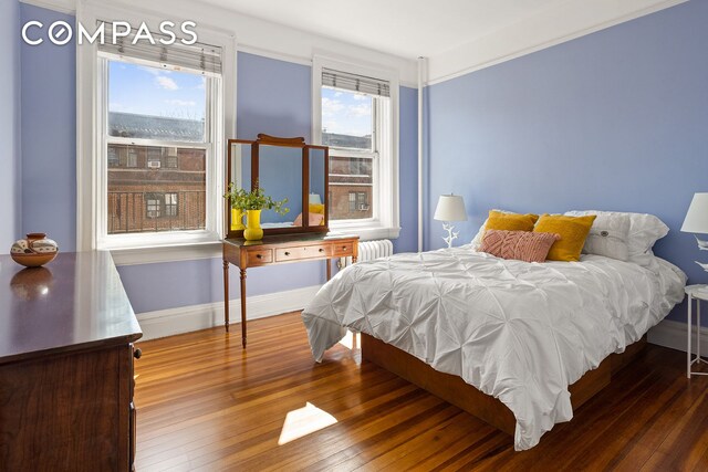 bedroom featuring hardwood / wood-style floors and baseboards